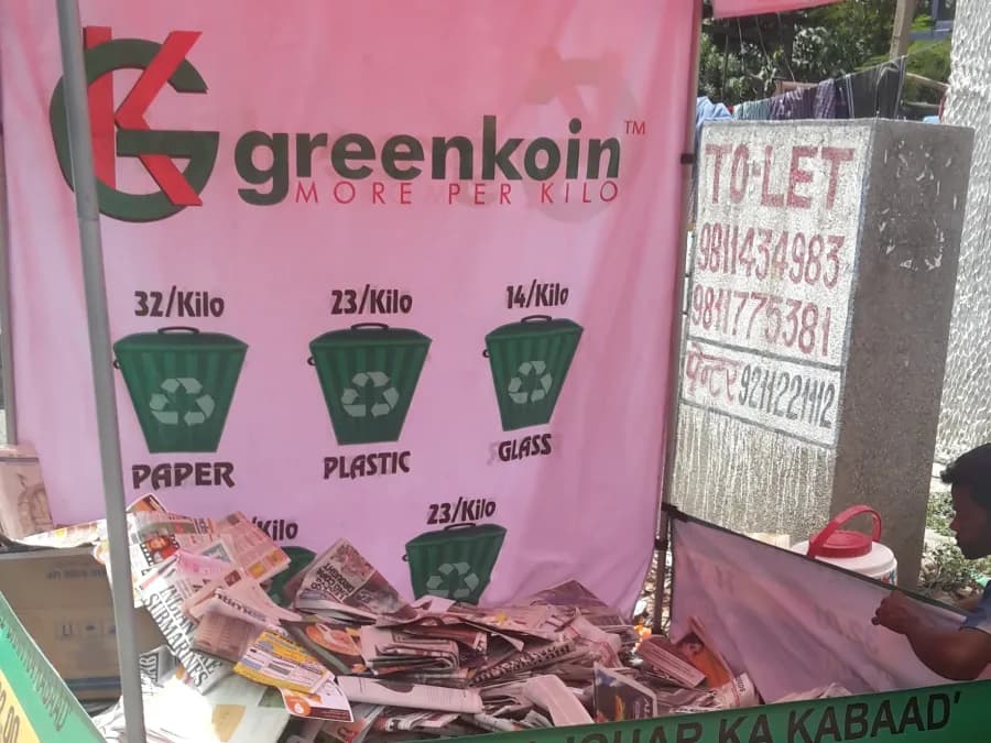 A resident handing over stored plastic in exchange for rewards.